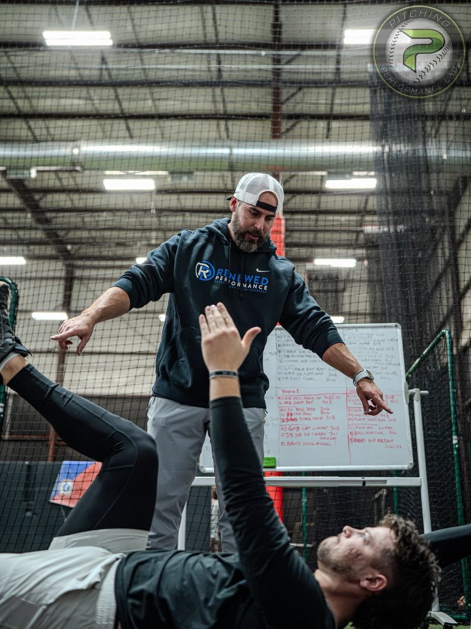 A PPL coach running a movement assessment